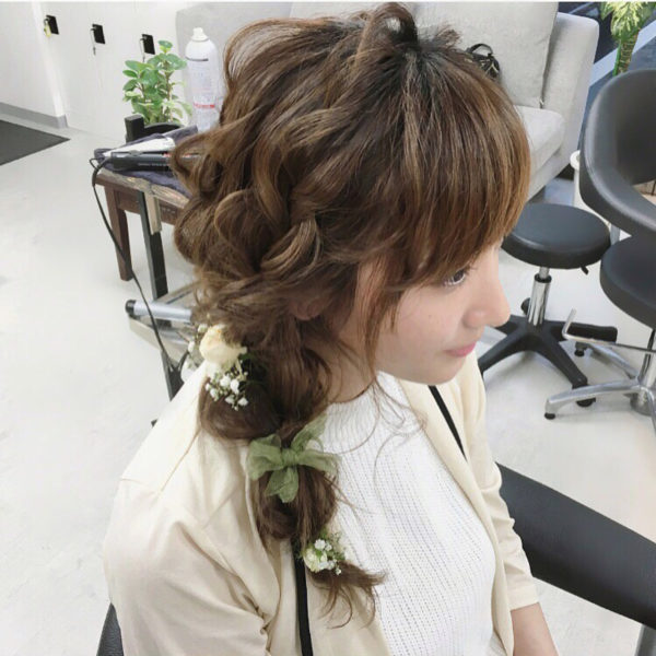 サイド寄せヘアは、女性らしく結婚式やパーティーシーンにもオススメ♪グリーン×ホワイトのヘアアクセで春っぽさを演出。